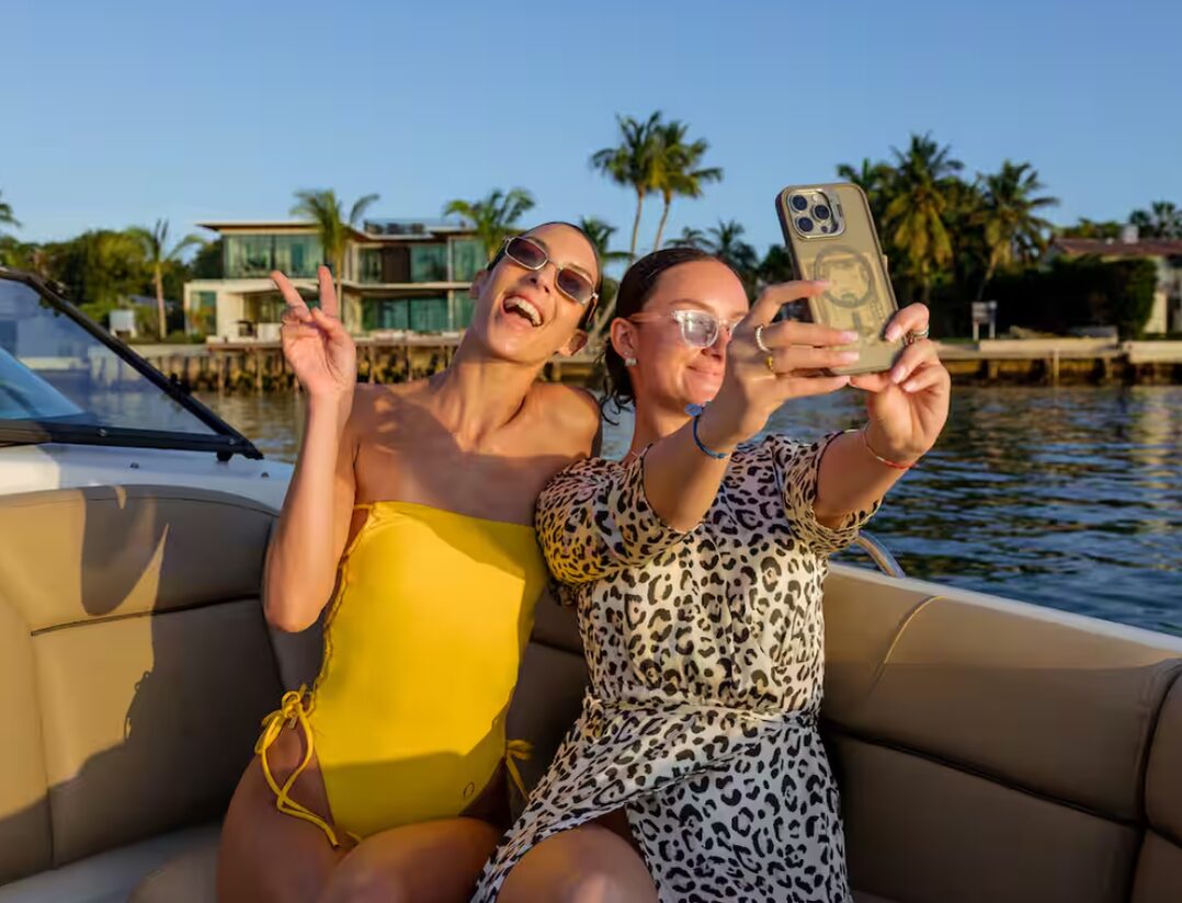Two guests taking a selfie on board a private 1 Life Boat Rental charter in Miami Beach