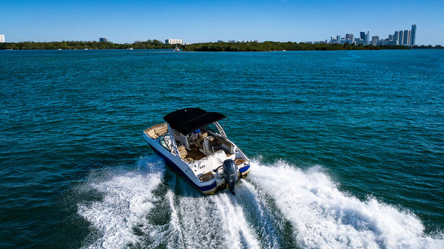 1 Life Boat Rental Nautic Star 25ft powering through Miami waters with skyline